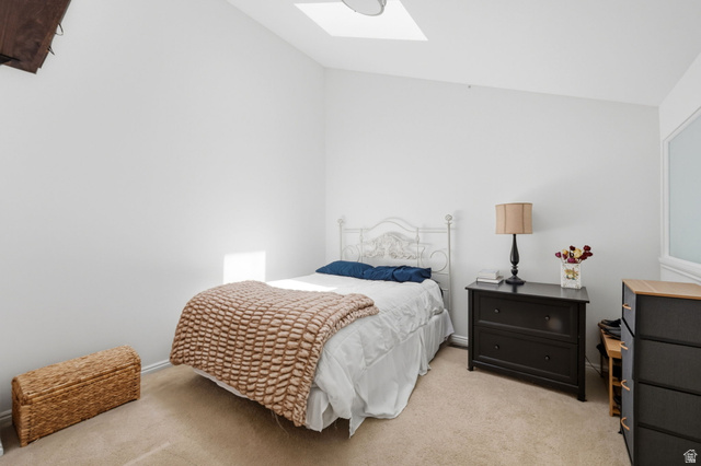 650 South Main Street, Unit 3304 Bountiful, UT 84010 - Photo 12 of 22 Carpeted room featuring a white painted vaulted ceiling, a skylight, and white walls