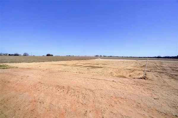 a view of a field with an ocean