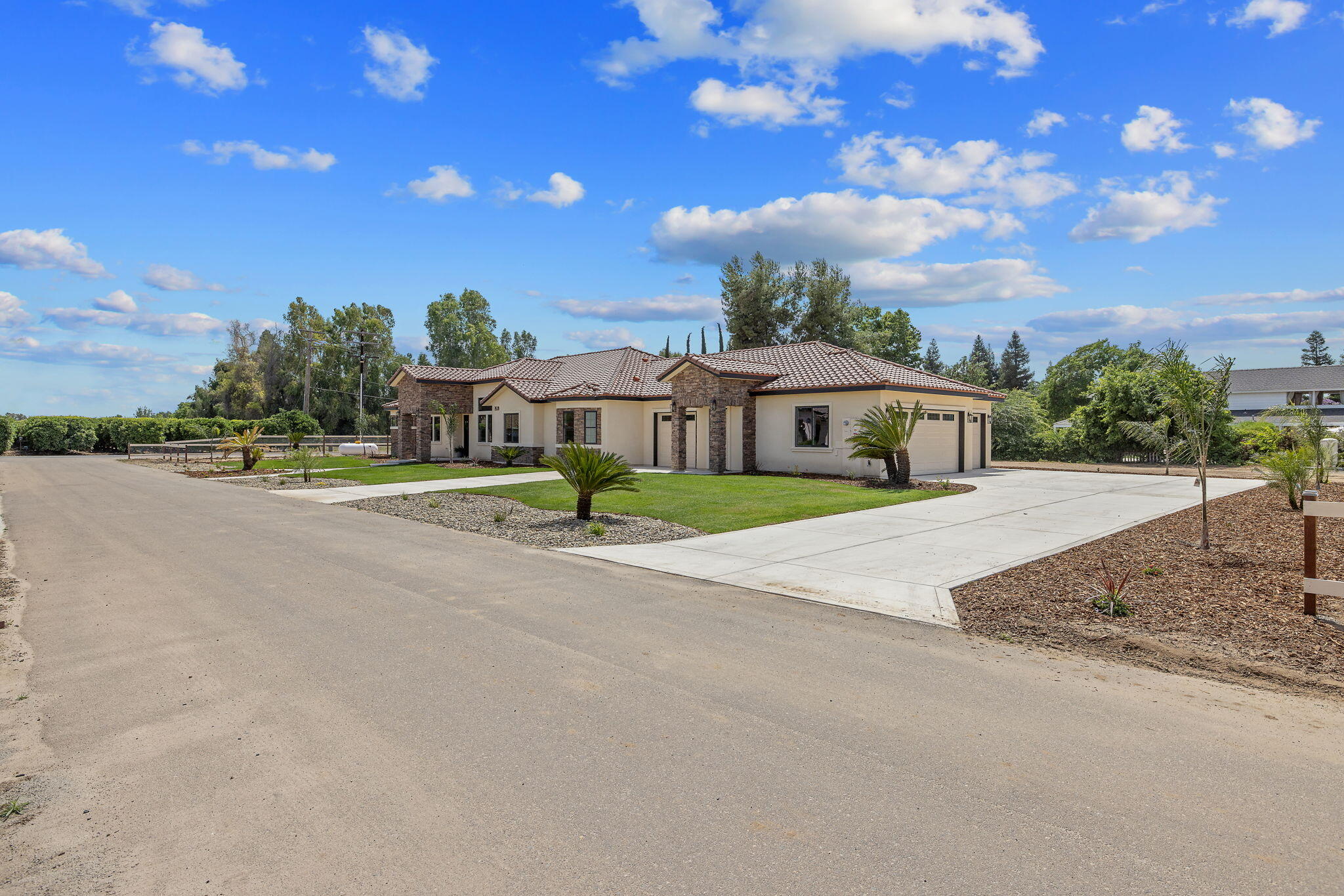 503 East Palm Street Exeter, CA 93221 - Photo 4 of 92 a front view of a house with a yard and road
