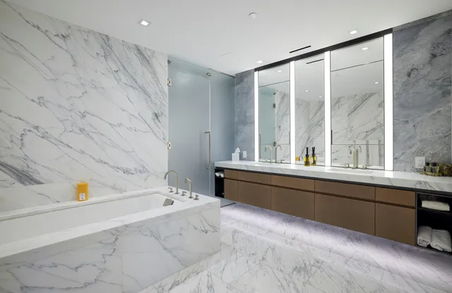 a bedroom with a bed and large window