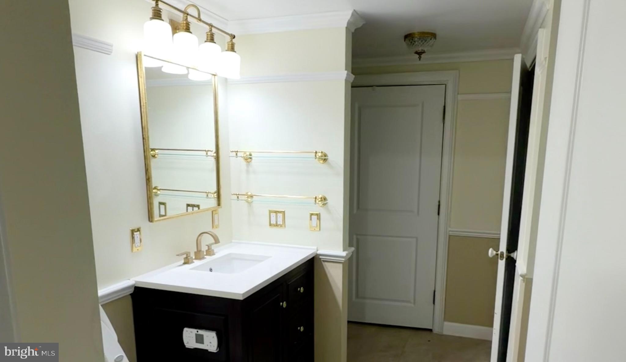 555 Massachusetts Avenue Northwest, Unit 815 Washington, DC 20001 - Photo 16 of 20 a bathroom with a sink a mirror and a shower
