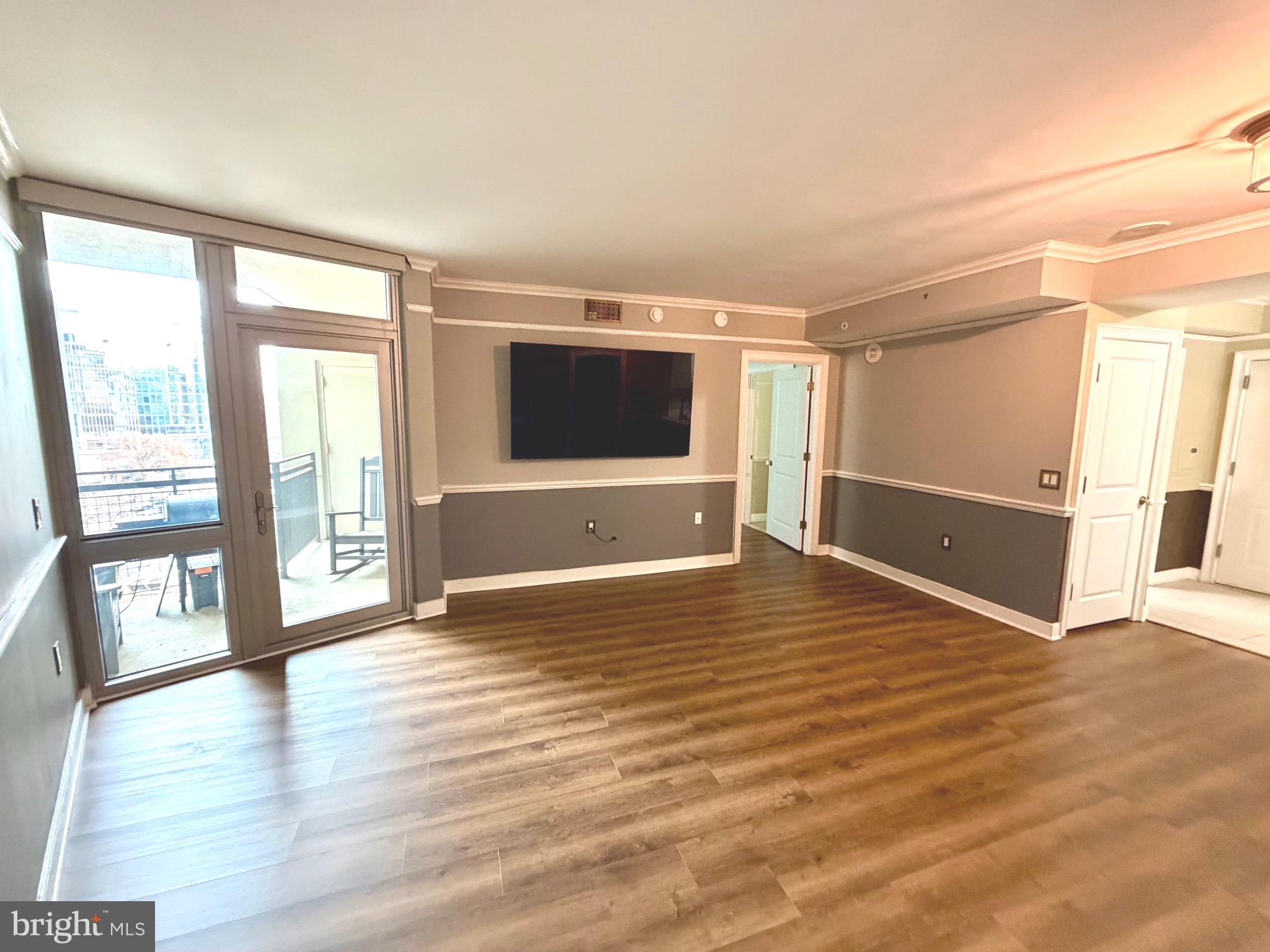 555 Massachusetts Avenue Northwest, Unit 815 Washington, DC 20001 - Photo 20 of 20 a view of an empty room with window and wooden floor