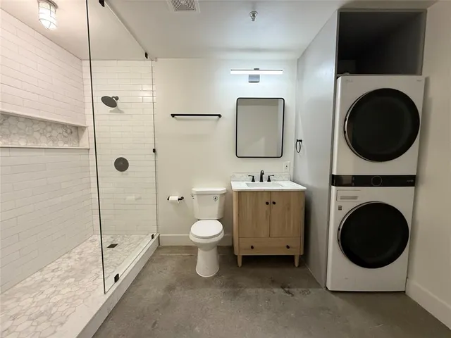 a spacious bathroom with a toilet a sink and a mirror