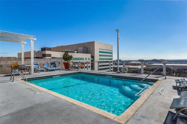 a view of a swimming pool with outdoor seating