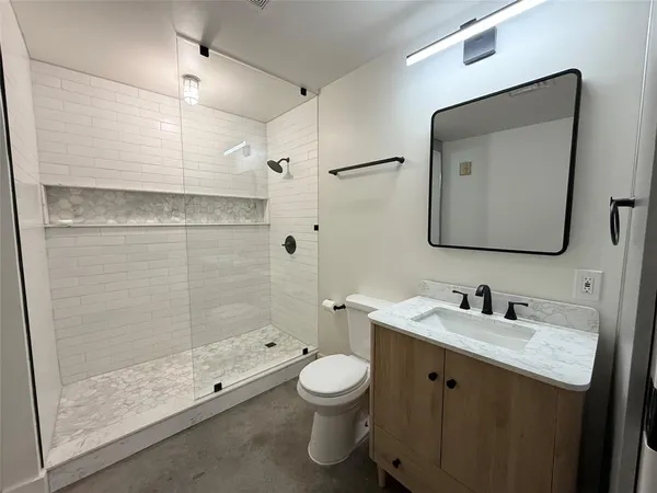 a bathroom with a toilet sink double and mirror