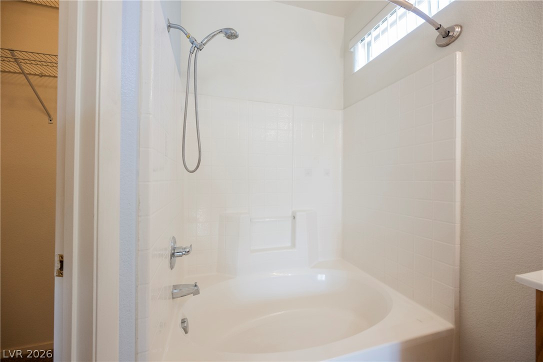 6320 Snap Ridge Street, Unit 201 North Las Vegas, NV 89081 - Photo 29 of 56 A deep soaking tub with a shower combo, ideal for unwinding after a long day.