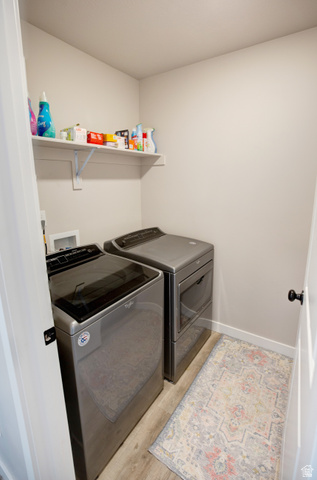 983 South 950 West Provo, UT 84601 - Photo 47 of 56 Dedicated laundry space featuring a white wall shelf, light gray wall paint, and wood-finish flooring