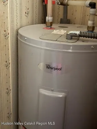 a view of house with backyard tub and seating space