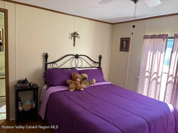 a bedroom with a bed and a night stand