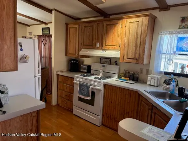 a kitchen with a stove a sink and a refrigerator