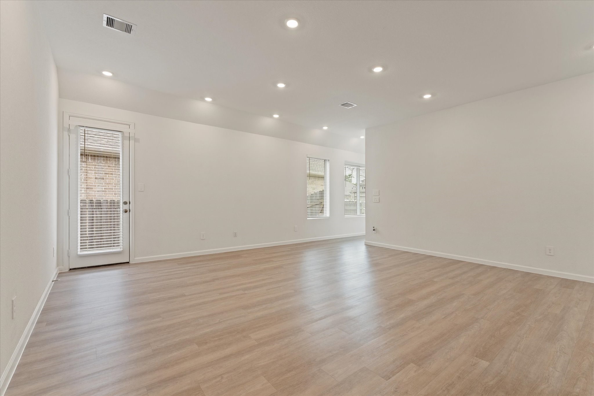 15520 Sunset Maple Court Conroe, TX 77302 - Photo 8 of 46 a view of an empty room with wooden floor and a window
