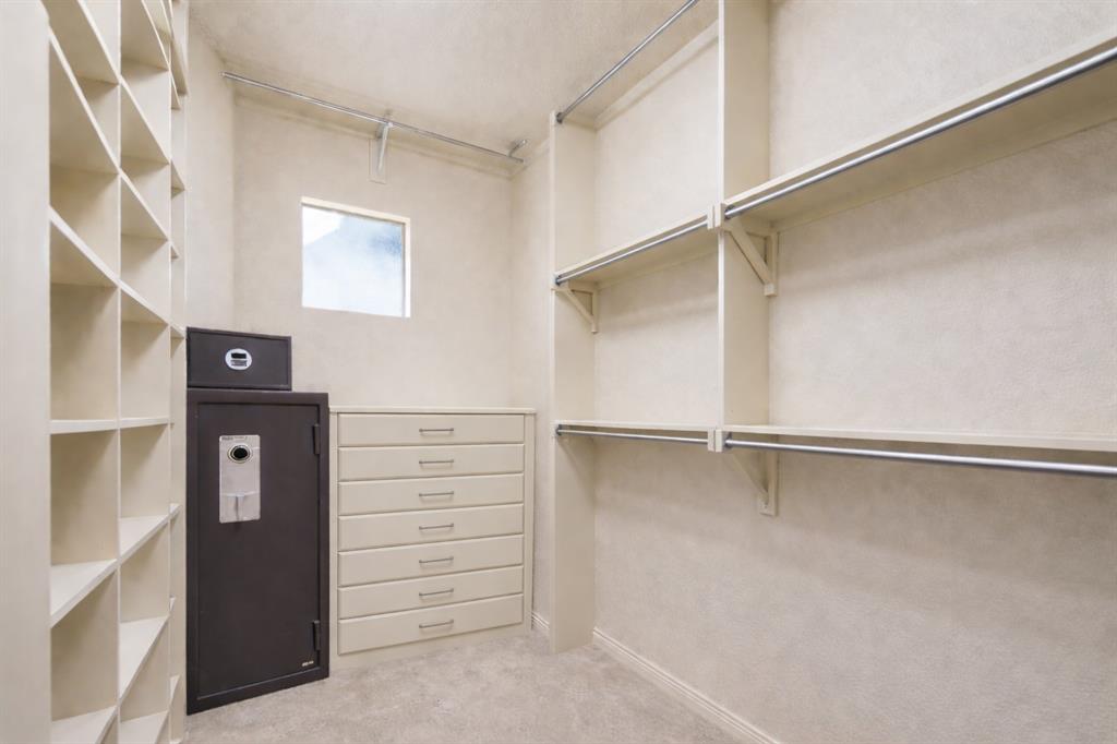 1520 Snider Court Lucas, TX 75002 - Photo 16 of 40 The primary bedroom closet features a built-in safe, shelving, and hanging rods, offering plenty of storage space.
