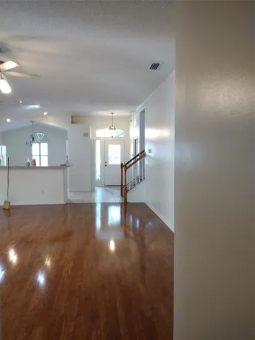 a view of a hallway with wooden floor