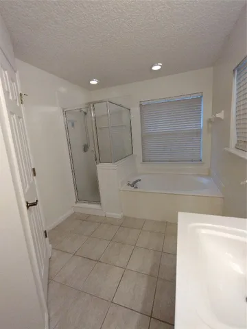 a bathroom with a bathtub and a shower