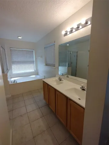 a bathroom with a sink vanity and mirror