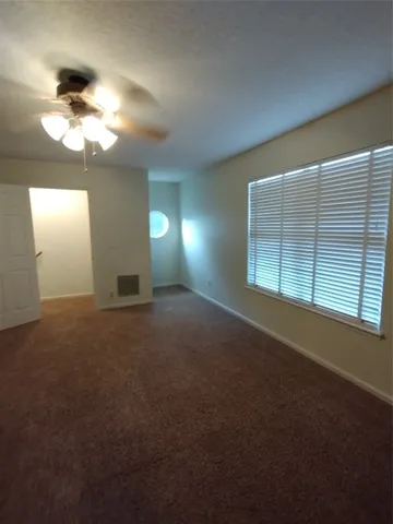a view of empty room with window and fireplace