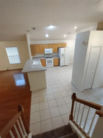 a view of a kitchen with furniture and wooden floor