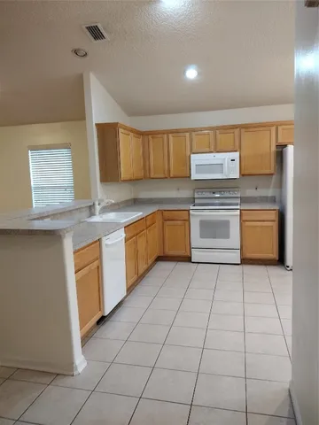 a kitchen with stainless steel appliances granite countertop a sink and cabinets