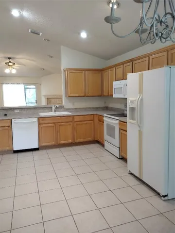 a kitchen with cabinets and white stainless steel appliances