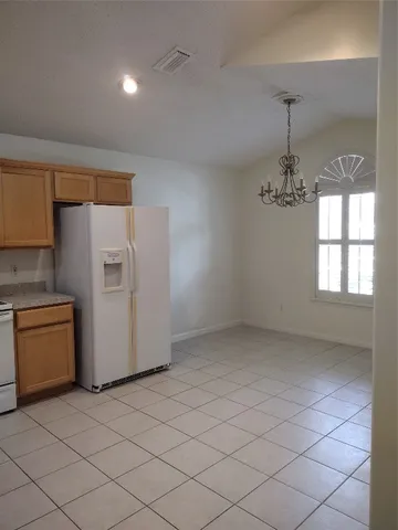 an empty room with a kitchen and a sink