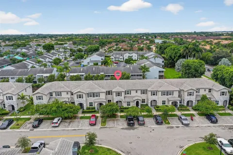 an aerial view of multiple houses with a yard