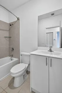 a bathroom with a toilet and a bath tub