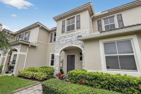 a view of a house with more windows and plants
