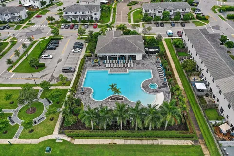 an aerial view of a house a yard and outdoor seating