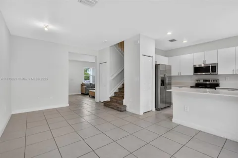 a kitchen with appliances a sink and a counter top space