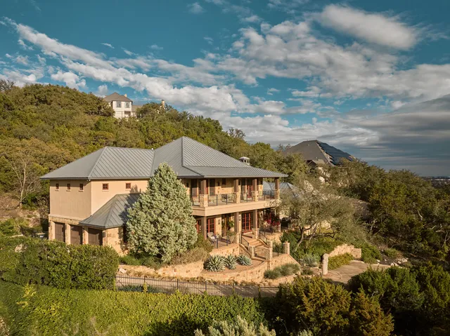 a view of a big yard with large trees