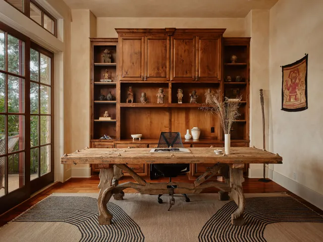 a view of a workspace with furniture and a potted plant
