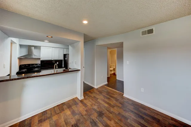 a view of a kitchen with a sink and a refrigerator