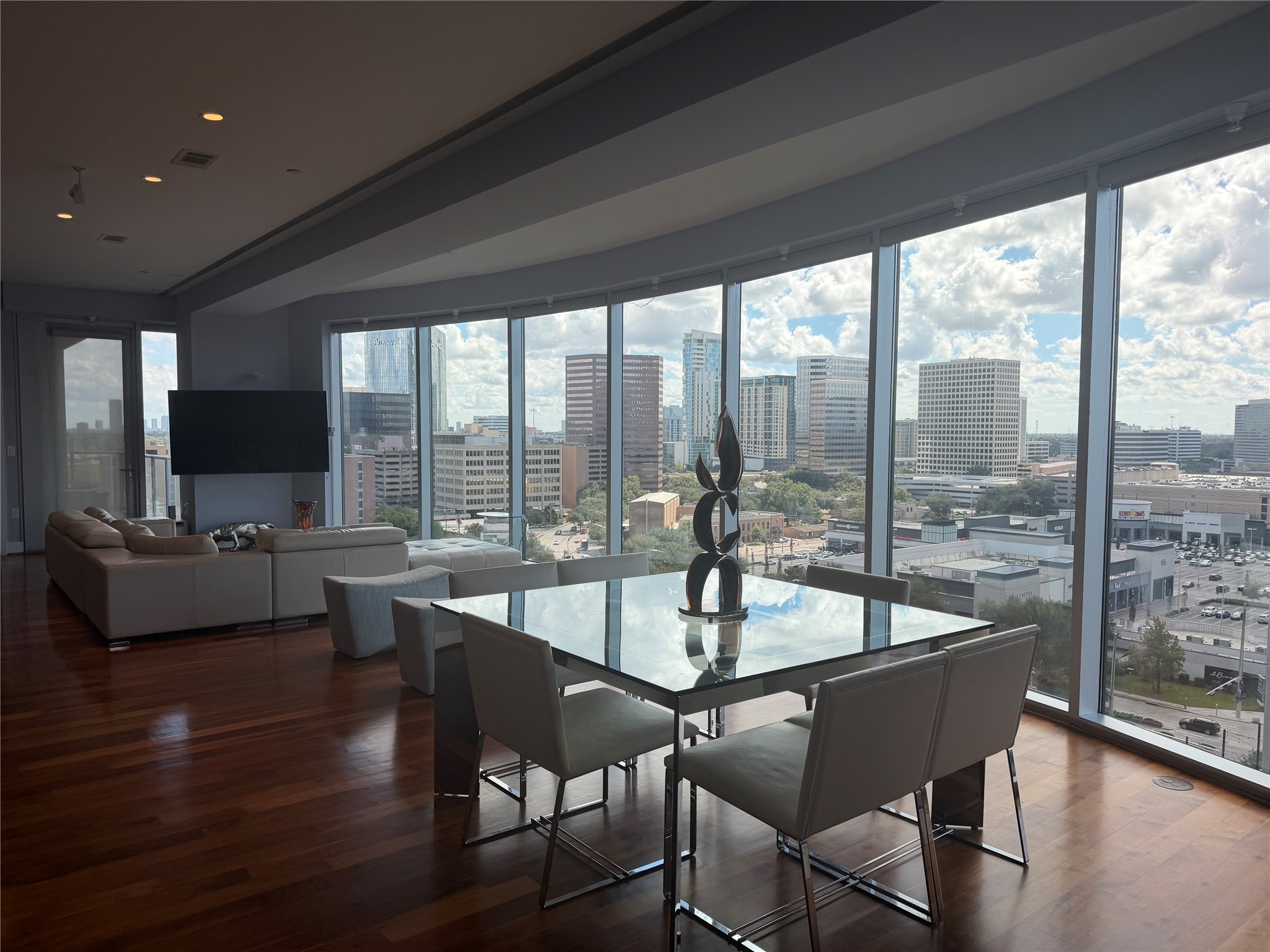 1600 Post Oak Boulevard, Unit 1206 Houston, TX 77056 - Photo 12 of 50 a dining room with wooden floor and a floor to ceiling window