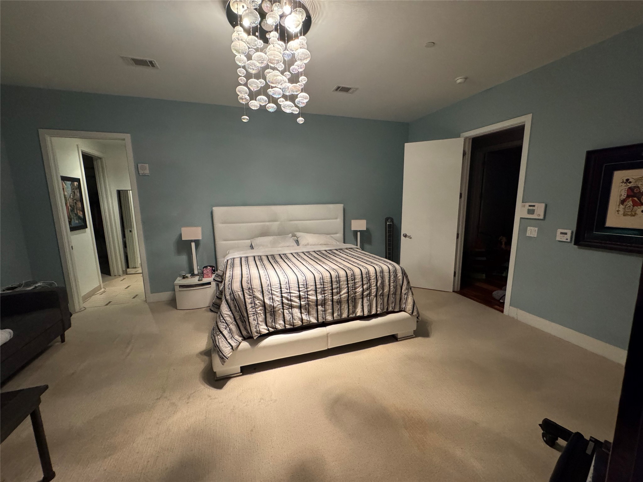 1600 Post Oak Boulevard, Unit 1206 Houston, TX 77056 - Photo 19 of 50 a bedroom with a large bed and a chandelier