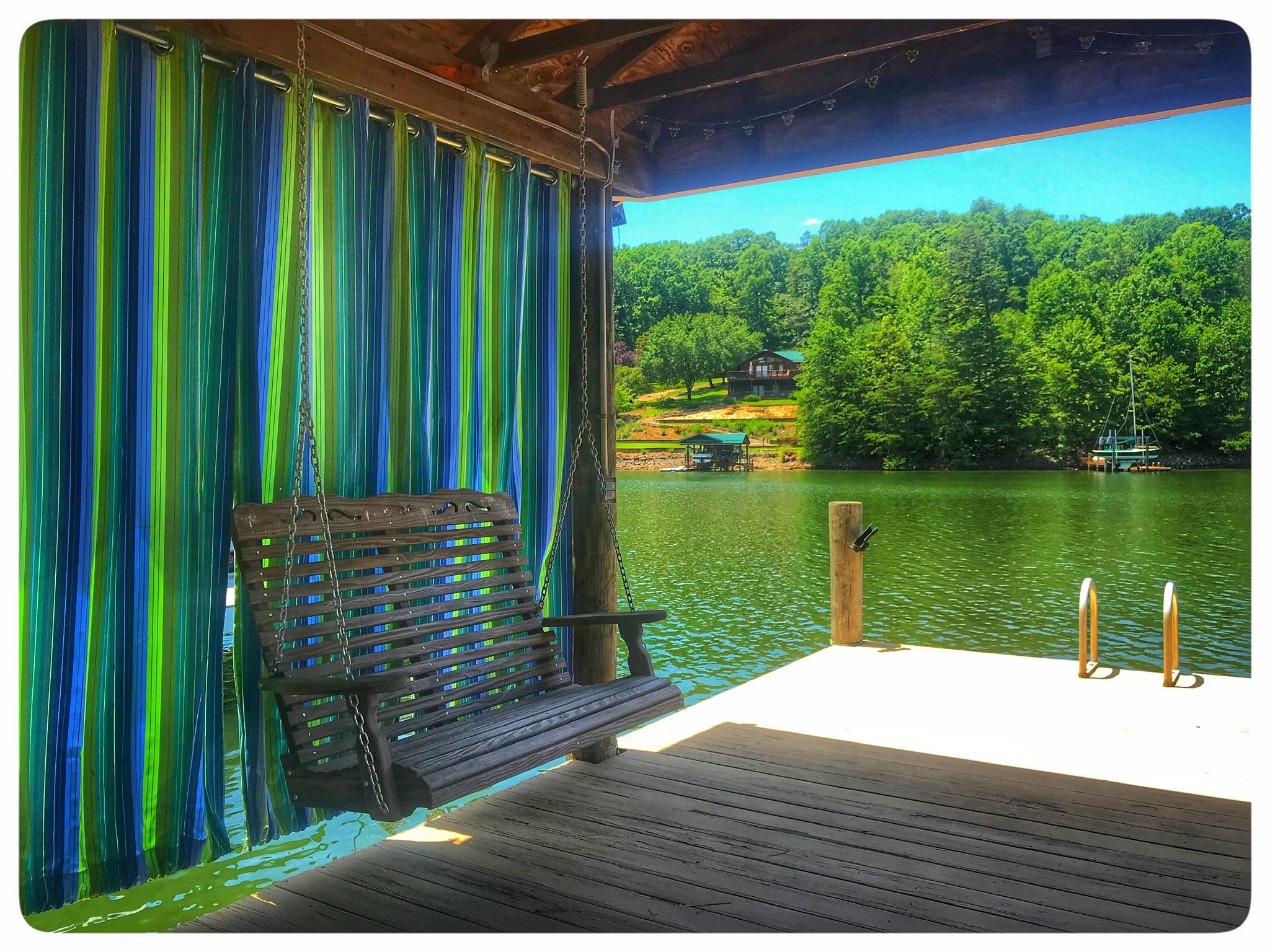 131 Highland Lake Road Union Hall, VA 24176 - Photo 32 of 75 a view of a lake with a floor to ceiling window next to a yard