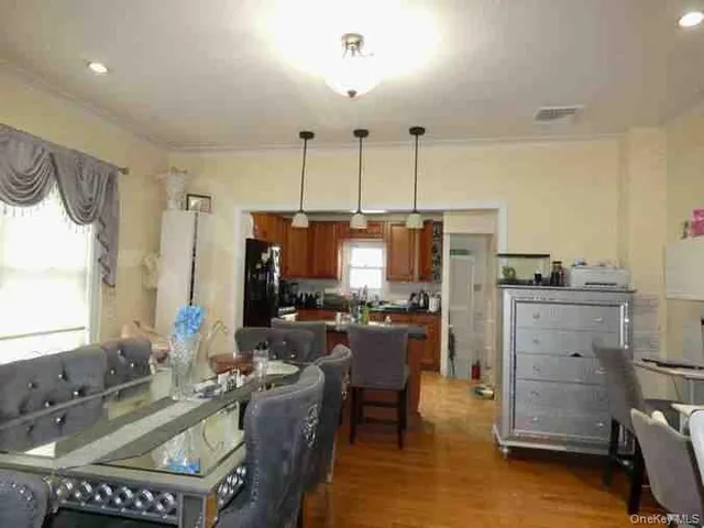 a room with furniture a chandelier a flat screen tv and a window