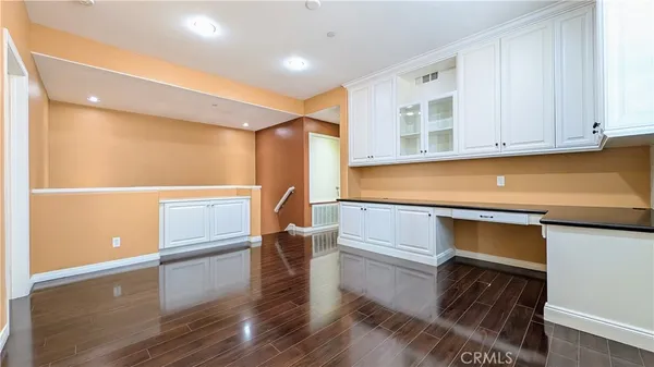 a kitchen with white cabinets and a sink