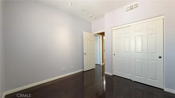 an empty room with wooden floor