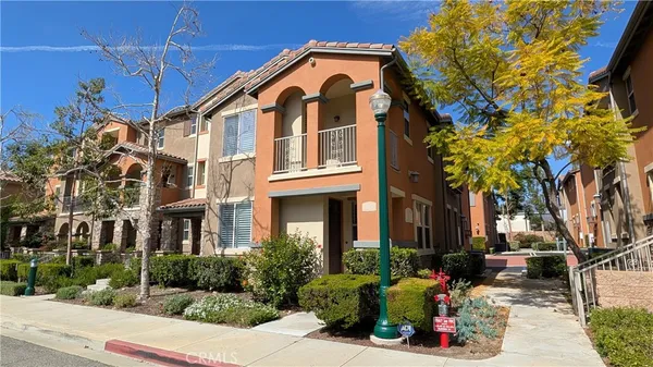 a front view of a building with tree s
