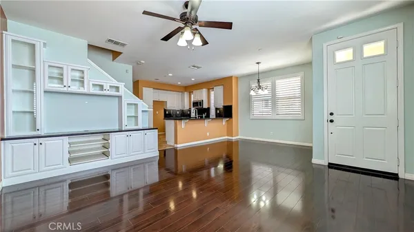 a view of kitchen with cabinets and wooden floor