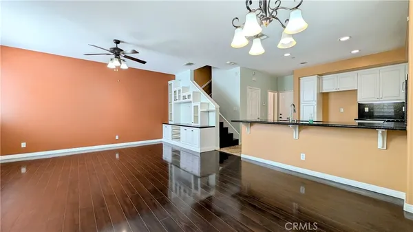 a view of a room with wooden floor and staircase