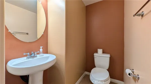 a bathroom with a sink a toilet and mirror
