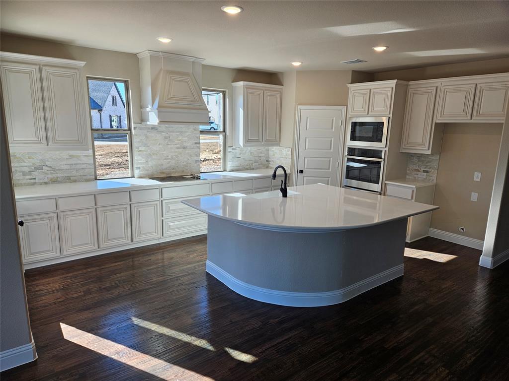 128 Red Fox Trail Godley, TX 76044 - Photo 4 of 19 a large kitchen with stainless steel appliances a large counter top