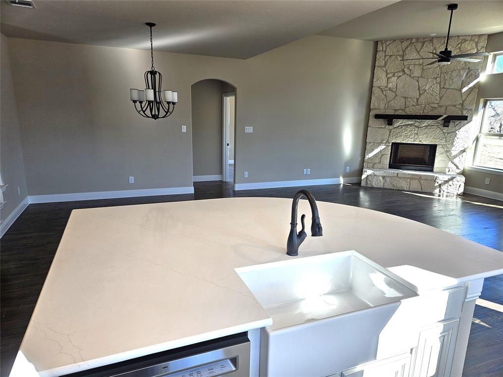 128 Red Fox Trail Godley, TX 76044 - Photo 7 of 19 a kitchen with a sink a counter and chairs