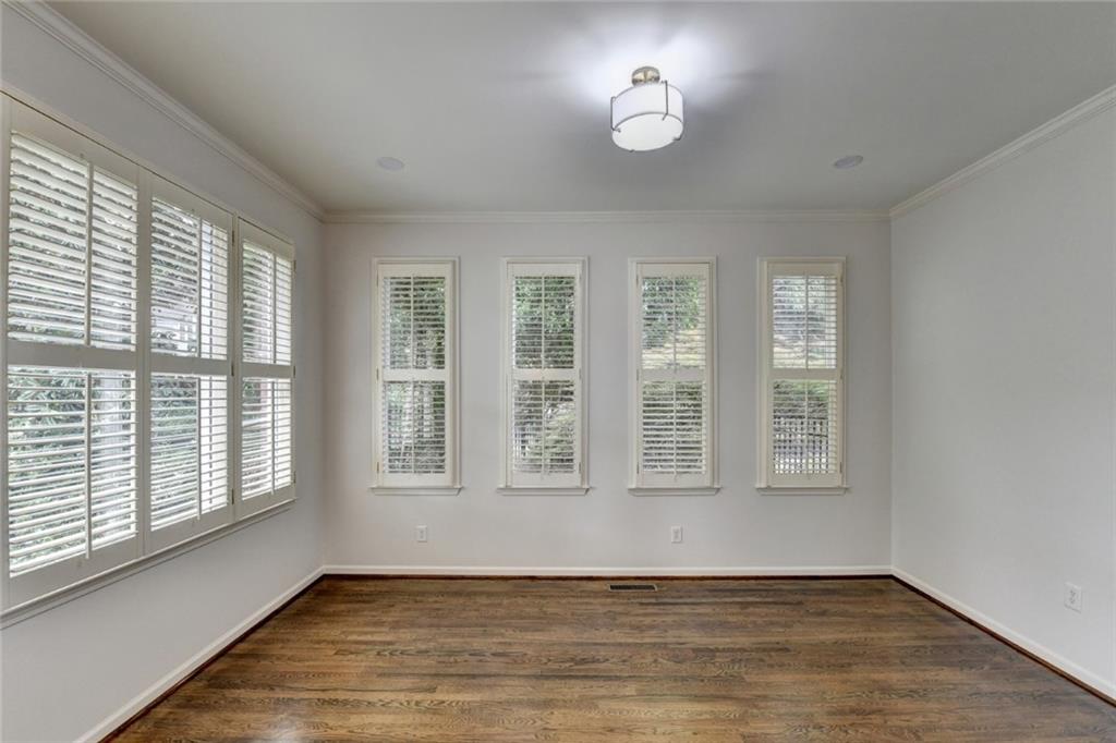 855 Autumn Close Alpharetta, GA 30004 - Photo 11 of 154 a view of an empty room with a window and wooden floor