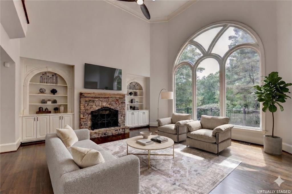 855 Autumn Close Alpharetta, GA 30004 - Photo 23 of 154 a living room with furniture a fireplace and a floor to ceiling window