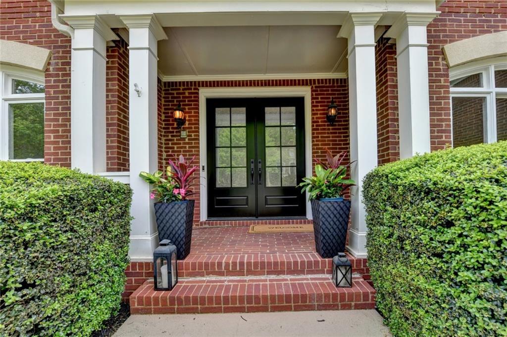 855 Autumn Close Alpharetta, GA 30004 - Photo 4 of 154 a view of a house with potted plants and a bench in front of house