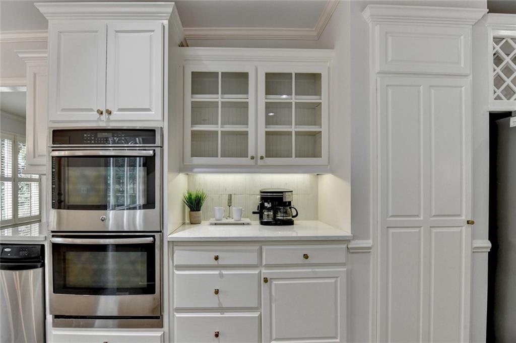 855 Autumn Close Alpharetta, GA 30004 - Photo 46 of 154 a kitchen with white cabinets and stainless steel appliances