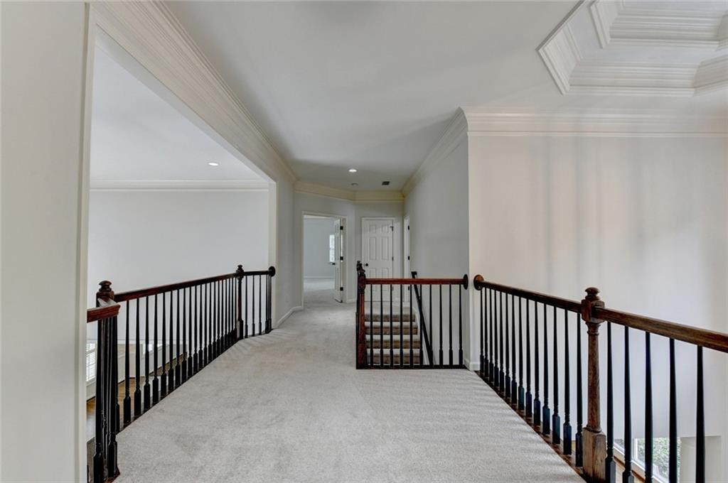 855 Autumn Close Alpharetta, GA 30004 - Photo 61 of 154 a view of a hallway with wooden floor and stairs