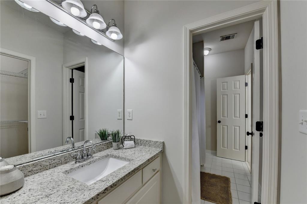 855 Autumn Close Alpharetta, GA 30004 - Photo 70 of 154 a bathroom with a granite countertop sink and a mirror